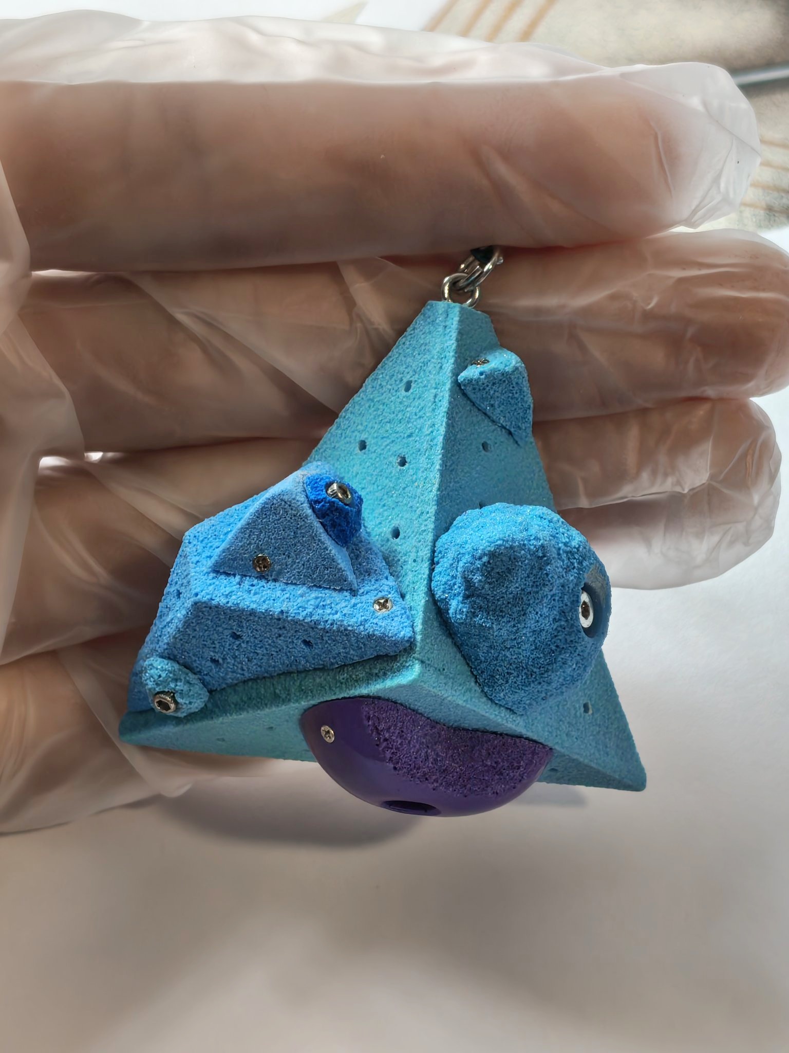 Blue miniature climbing volume with purple and blue holds