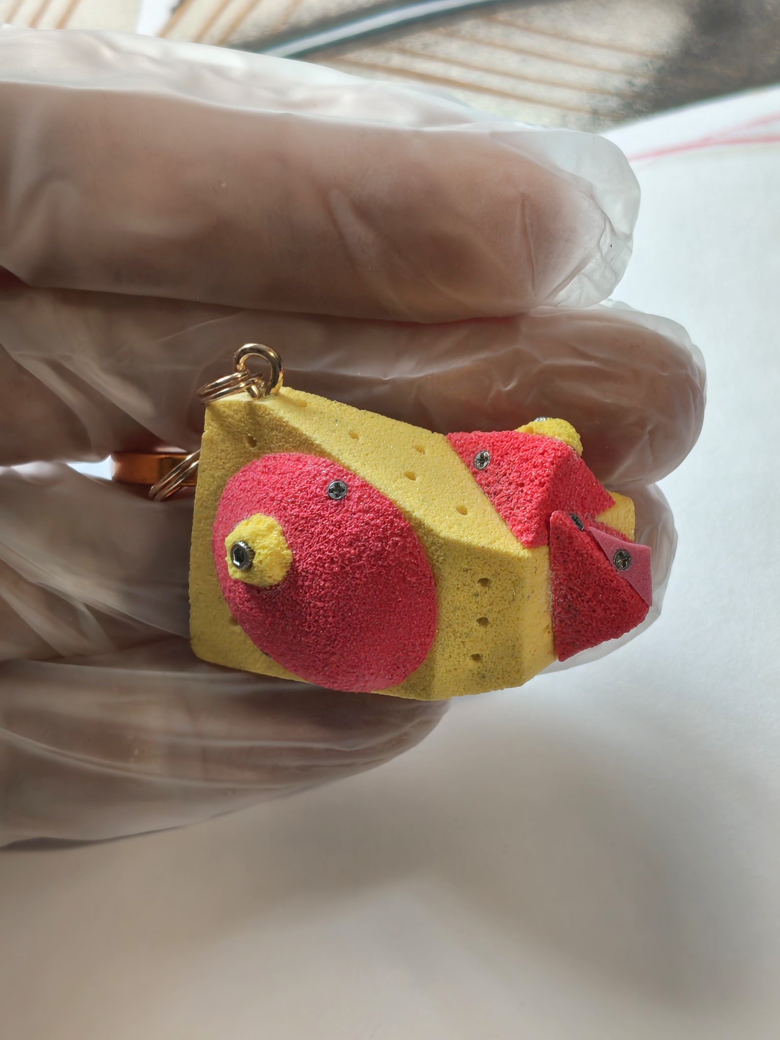 Yellow miniature volume with red holds