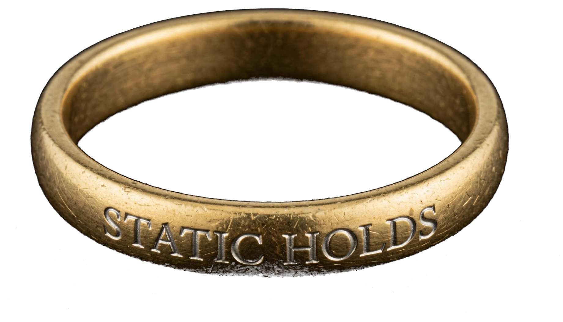 A naturally lit gold ring engraved with Static Holds in platinum Roman capitals